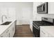 Contemporary kitchen with stainless steel appliances and white cabinetry at 754 N Tempe St, Aurora, CO 80018