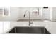 Close-up of a stainless steel kitchen sink and faucet with quartz countertops at 754 N Tempe St, Aurora, CO 80018