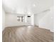 Bright living room with laminate wood flooring, a large window, and a modern front door and entry at 754 N Tempe St, Aurora, CO 80018