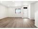 Bright living room featuring laminate wood flooring, a large window, and a modern front door at 754 N Tempe St, Aurora, CO 80018