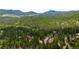 Gorgeous mountain property and neighborhood is seen from an aerial view among the forest at 10090 Blue Sky Trl, Conifer, CO 80433