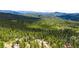 Beautiful aerial of mountain homes surrounded by vast forests and breathtaking mountain views at 10090 Blue Sky Trl, Conifer, CO 80433