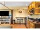Finished basement with custom wet bar and counter seating, laminate flooring and a large TV at 10090 Blue Sky Trl, Conifer, CO 80433