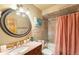 Elegant bathroom featuring tiled walls, granite countertop, a large mirror, and shower-tub combination at 10090 Blue Sky Trl, Conifer, CO 80433