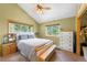 Bright bedroom with vaulted ceiling, large windows, a queen sized bed and custom bench seating at 10090 Blue Sky Trl, Conifer, CO 80433