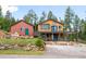 Charming mountain home with a large deck, rock landscaping, and a detached garage at 10090 Blue Sky Trl, Conifer, CO 80433