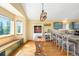 Spacious kitchen and dining area with wood floors, views of outdoors, and a custom copper sink at 10090 Blue Sky Trl, Conifer, CO 80433