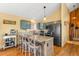 Stylish kitchen with island seating, pendant lighting, and stainless steel appliances at 10090 Blue Sky Trl, Conifer, CO 80433
