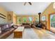 Inviting living room with hardwood floors, a cozy stove, and natural light at 10090 Blue Sky Trl, Conifer, CO 80433