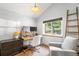Cozy home office features a built-in desk, natural light, and a comfortable chair, perfect for remote work at 10090 Blue Sky Trl, Conifer, CO 80433