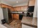 Kitchen featuring stainless steel refrigerator, granite countertops, black dishwasher, and light wood cabinets at 431 Wright St # 203, Lakewood, CO 80228
