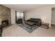 Cozy living room with a stone fireplace and sliding glass door with a view of the sky at 431 Wright St # 203, Lakewood, CO 80228