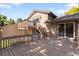 Lovely deck featuring wood railings and stairs that provide access to a second story balcony at 12674 E Bates Cir, Aurora, CO 80014