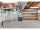 Unfinished basement with a utility sink, storage shelves, washer and dryer at 12674 E Bates Cir, Aurora, CO 80014