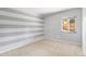 This bedroom offers carpeted floors, neutral paint and natural light from the outdoor view at 12674 E Bates Cir, Aurora, CO 80014