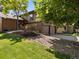 Well-maintained home with brick accents, mature trees, and a welcoming landscaped front yard at 12674 E Bates Cir, Aurora, CO 80014