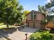 Charming two-story home with a two-car garage, manicured lawn, and attractive landscaping at 12674 E Bates Cir, Aurora, CO 80014
