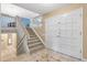 Bright foyer featuring a staircase with white railing, tiled flooring, and a paneled front door at 12674 E Bates Cir, Aurora, CO 80014