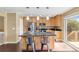 Bright kitchen featuring wood cabinets, stainless appliances, a granite-topped island and access to the back deck at 12674 E Bates Cir, Aurora, CO 80014