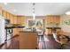 Well-lit kitchen with an island, stainless steel appliances, wood cabinets, and hardwood floors at 12674 E Bates Cir, Aurora, CO 80014
