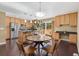 Spacious open floor plan with kitchen island, stainless appliances, sliding glass doors to deck and cozy dining area at 12674 E Bates Cir, Aurora, CO 80014