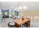 Open-concept living area with vaulted ceilings, dining space, and bright natural light at 12674 E Bates Cir, Aurora, CO 80014