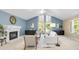 Inviting living room with vaulted ceilings, fireplace, large windows, and neutral decor at 12674 E Bates Cir, Aurora, CO 80014