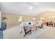 Spacious living area with vaulted ceiling, comfortable seating, and a view of the adjacent dining area at 12674 E Bates Cir, Aurora, CO 80014