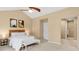 Bright main bedroom features vaulted ceilings, ceiling fan, two abstract art pieces, and access to ensuite bathroom at 12674 E Bates Cir, Aurora, CO 80014