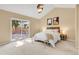 Bright main bedroom with vaulted ceilings, ceiling fan, cozy decor, and glass doors to the outdoor deck at 12674 E Bates Cir, Aurora, CO 80014