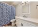 Bathroom featuring a white vanity, a single sink, and a bathtub with a stylish blue shower curtain at 675 S Alton Way # 7A, Denver, CO 80247
