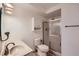 Bathroom featuring a granite vanity top, walk-in shower with glass door, and storage cabinet at 675 S Alton Way # 7A, Denver, CO 80247