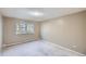 Bright bedroom with wall to wall carpet, neutral walls, and window at 675 S Alton Way # 7A, Denver, CO 80247