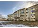 Attractive condominium building with a well-kept lawn and inviting entryway for residents and guests at 675 S Alton Way # 7A, Denver, CO 80247