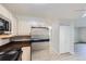 Kitchen with stainless steel refrigerator and light wood cabinets at 675 S Alton Way # 7A, Denver, CO 80247