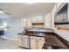 Galley kitchen with wood countertops, stainless steel appliances, and light wood cabinets at 675 S Alton Way # 7A, Denver, CO 80247