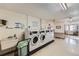 Community laundry room featuring multiple washers and dryers, a sink, and a folding table at 675 S Alton Way # 7A, Denver, CO 80247