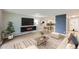 Open living room featuring a TV, neutral paint, an area rug, dining table, and modern furniture at 675 S Alton Way # 7A, Denver, CO 80247