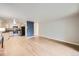 Living room and kitchen combination with natural light and hardwood flooring at 675 S Alton Way # 7A, Denver, CO 80247