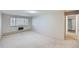 Large bedroom with a window, door to hallway, and neutral carpeting at 675 S Alton Way # 7A, Denver, CO 80247