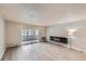 Open floor plan with modern electric fireplace and sliding glass doors to the patio at 675 S Alton Way # 7A, Denver, CO 80247