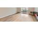 Living room with wood-look flooring and access to a patio at 675 S Alton Way # 7A, Denver, CO 80247