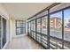 Enclosed patio with tile floor, glass windows, and view of outdoor community at 675 S Alton Way # 7A, Denver, CO 80247