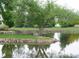 Scenic pond with ducks swimming and greenery, creating a peaceful outdoor area for residents at 675 S Alton Way # 7A, Denver, CO 80247