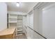 Spacious walk-in closet featuring built-in shelving and hanging rods for optimal organization at 675 S Alton Way # 7A, Denver, CO 80247