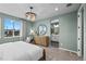 Bright bedroom with a view, round mirror, and ensuite bathroom at 9487 W 58Th Ln # C, Arvada, CO 80002