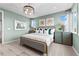 Bright bedroom featuring neutral color palette, framed art, and a contemporary light fixture at 9487 W 58Th Ln # C, Arvada, CO 80002