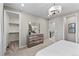 Bedroom showcasing dresser, walk-in closet, staircase access and a modern ceiling light at 9487 W 58Th Ln # C, Arvada, CO 80002
