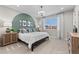 Inviting bedroom with a unique green accent wall, decorative pillows and large window at 9487 W 58Th Ln # C, Arvada, CO 80002