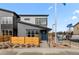 Modern two-story home boasting a blue door, wood fencing, and professional landscaping at 9487 W 58Th Ln # C, Arvada, CO 80002